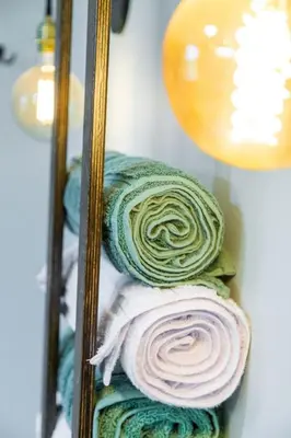 a pile of towels on a shelf in a mirror at Unique Stay! Ricketts Chic Farmhouse Retreat with Stargazing Bubble Tent in Stillwater