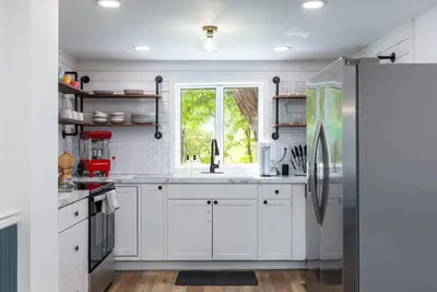 a kitchen with white cabinets and a window at Unique Stay! Ricketts Chic Farmhouse Retreat with Stargazing Bubble Tent in Stillwater
