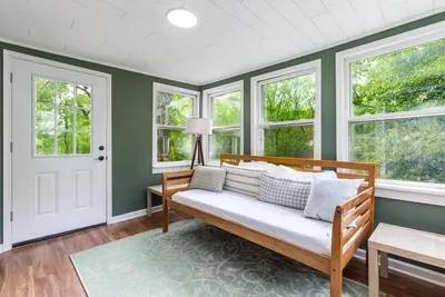 a living room with a bench and windows at Unique Stay! Ricketts Chic Farmhouse Retreat with Stargazing Bubble Tent in Stillwater