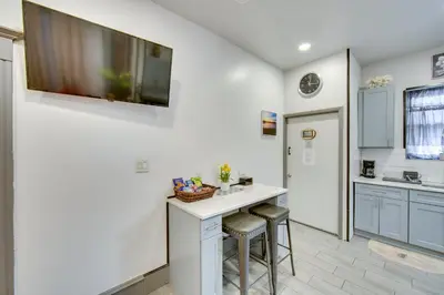 a kitchen with a white counter and stools at Less Than 2 Mi to Downtown and Capitol Harrisburg Hideaway in Harrisburg