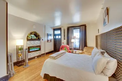 a bedroom with a large bed and a fireplace at Less Than 2 Mi to Downtown and Capitol Harrisburg Hideaway in Harrisburg