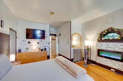 a bedroom with a large bed and a fireplace at Less Than 2 Mi to Downtown and Capitol Harrisburg Hideaway in Harrisburg