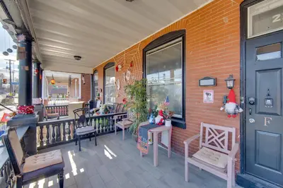 a front porch of a store with chairs and a door at Less Than 2 Mi to Downtown and Capitol Harrisburg Hideaway in Harrisburg