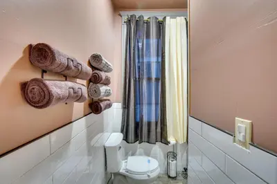 a bathroom with a toilet and towels on the wall at Less Than 2 Mi to Downtown and Capitol Harrisburg Hideaway in Harrisburg