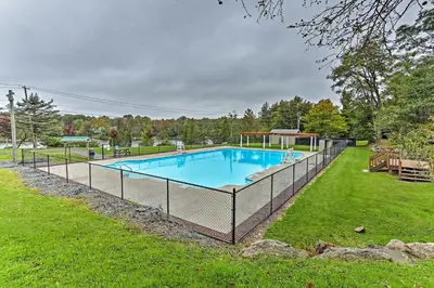 a swimming pool with a fence around it in a yard at A Time to Remember Home in Tobyhanna with Pool! in Tobyhanna
