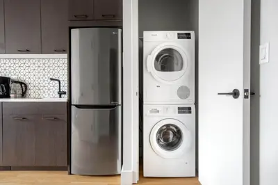 a kitchen with a refrigerator and a washer and dryer at East Village 2br w doorman wd nr Union Square NYC-1185 in New York
