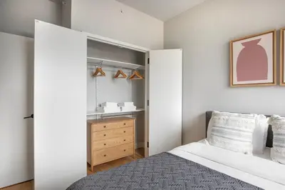 a bedroom with a bed and a wooden dresser at East Village 2br w doorman wd nr Union Square NYC-1185 in New York