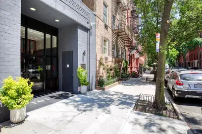 a street with a car parked next to a building at East Village 2br w doorman wd nr Union Square NYC-1185 in New York