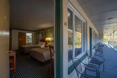 a hotel room with a bed and a balcony at Mahoning Inn in Lehighton