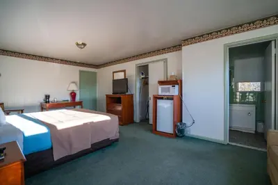 a hotel room with a bed and a television at Mahoning Inn in Lehighton