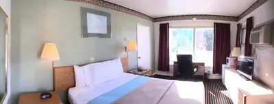 a hotel room with a bed and a television at Mahoning Inn in Lehighton