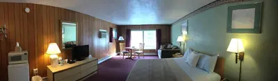a hotel room with a bed and a living room at Mahoning Inn in Lehighton