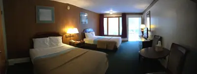 a hotel room with two beds and a table at Mahoning Inn in Lehighton