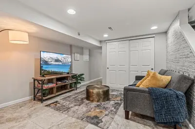 a living room with a couch and a tv at Uptown Gem! Immaculate-Comfort-Character! in Philadelphia