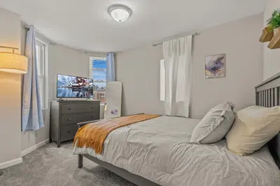 a bedroom with a bed and a television in it at Uptown Gem! Immaculate-Comfort-Character! in Philadelphia