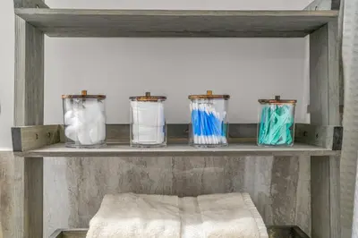 a shelf with four glass jars on it at Uptown Gem! Immaculate-Comfort-Character! in Philadelphia