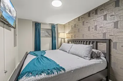 a bedroom with a bed and a wall at Uptown Gem! Immaculate-Comfort-Character! in Philadelphia