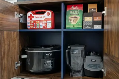a cupboard with a coffee maker and other items on it at Uptown Gem! Immaculate-Comfort-Character! in Philadelphia