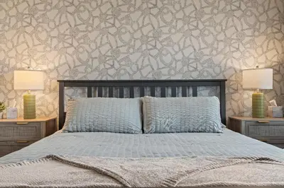 a bedroom with a bed with two lamps on tables at Uptown Gem! Immaculate-Comfort-Character! in Philadelphia