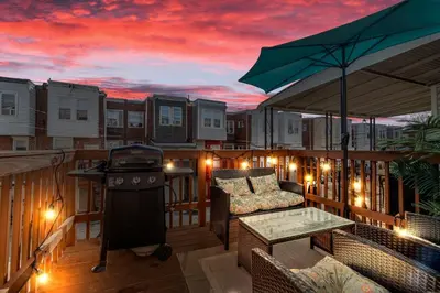 a deck with a grill and a table with a barbecue at Uptown Gem! Immaculate-Comfort-Character! in Philadelphia