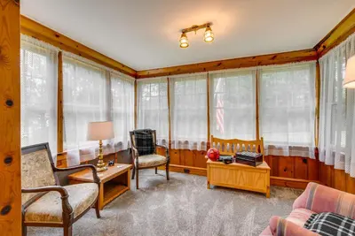 a living room with wooden walls and windows at 8 Mi to Elk Mountain Ski Resort Clifford Home! in Clifford
