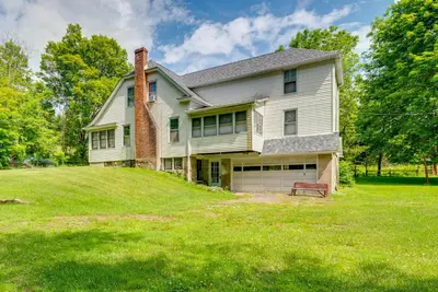 a house on a hill with a bench in the yard at 8 Mi to Elk Mountain Ski Resort Clifford Home! in Clifford