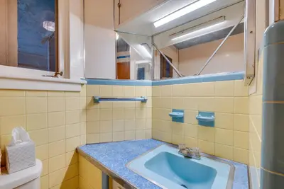 a bathroom with a sink and a mirror at 8 Mi to Elk Mountain Ski Resort Clifford Home! in Clifford