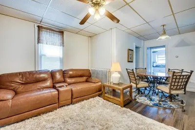 a living room with a couch and a table at Pool Access Bath Vacation Rental Condo! in Hollo