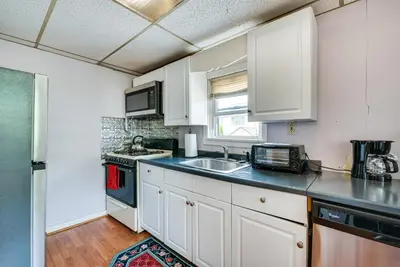 a kitchen with white cabinets and a sink at Pool Access Bath Vacation Rental Condo! in Hollo