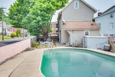 a swimming pool in front of a house at Pool Access Bath Vacation Rental Condo! in Hollo