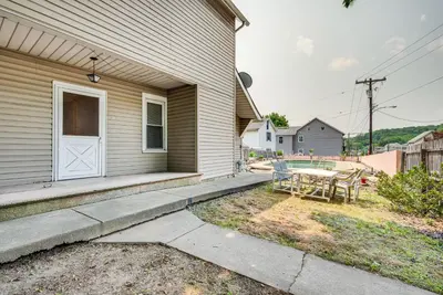 a house with a white door and a table at Pool Access Bath Vacation Rental Condo! in Hollo