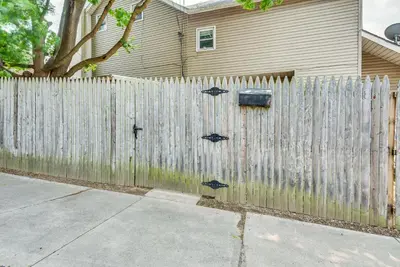 a wooden fence in front of a house at Pool Access Bath Vacation Rental Condo! in Hollo