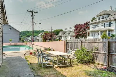 a backyard with a table and chairs next to a fence at Pool Access Bath Vacation Rental Condo! in Hollo