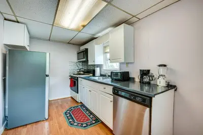a kitchen with white cabinets and a stainless steel refrigerator at Pool Access Bath Vacation Rental Condo! in Hollo
