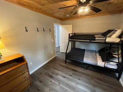 a room with two bunk beds and a ceiling fan at Wally's House in Hawley