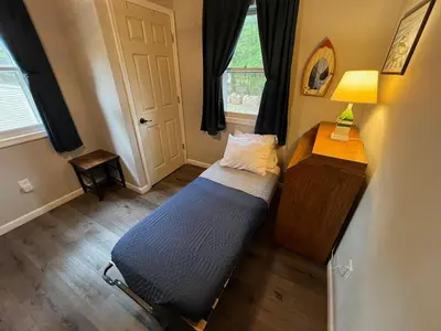 a bedroom with a bed and a table and a window at Wally's House in Hawley