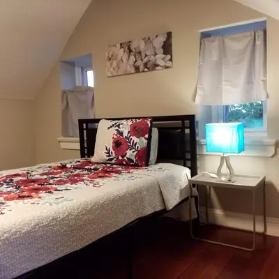 a bedroom with a bed with a pillow and a lamp at Fairmount House Free Street Parking Quiet Spacious in Philadelphia