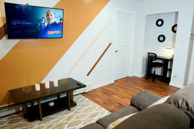 a living room with a couch and a tv on the wall at Serene Escape Leave Worries Behind in Wilkes-Barre