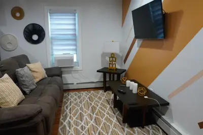 a living room with a couch and a tv at Serene Escape Leave Worries Behind in Wilkes-Barre