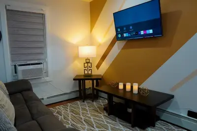 a living room with a couch and a flat screen tv at Serene Escape Leave Worries Behind in Wilkes-Barre
