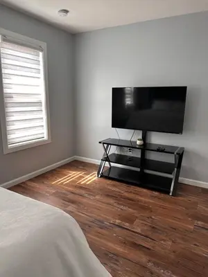 a bedroom with a flat screen tv on the wall at Serene Escape Leave Worries Behind in Wilkes-Barre