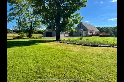 a large yard with a house and a tree at Upstate getaway. Leave your troubles behind. in Unadilla