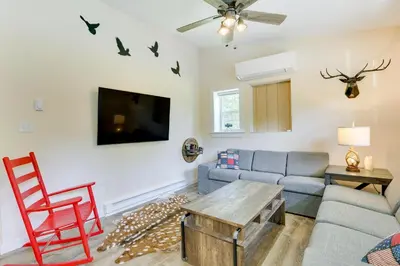 a living room with a couch and a tv at Secluded Poconos Cabin 75 Acres and Fire Pit! in East Stroudsburg