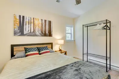 a bedroom with a bed and a glass shower at Secluded Poconos Cabin 75 Acres and Fire Pit! in East Stroudsburg