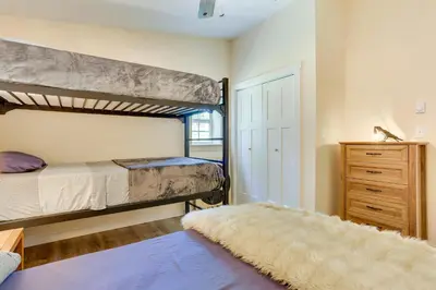 a bedroom with a bunk bed and a dresser at Secluded Poconos Cabin 75 Acres and Fire Pit! in East Stroudsburg
