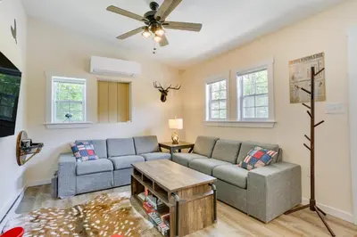 a living room with two couches and a ceiling fan at Secluded Poconos Cabin 75 Acres and Fire Pit! in East Stroudsburg