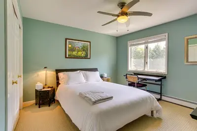 a bedroom with a bed and a ceiling fan at Warwick Vacation Rental with Private Yard and Fire Pit in Warwick