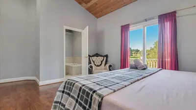 a bedroom with a large bed and a window at Luxury Lake Front Camelot Villa in Pocono Lake