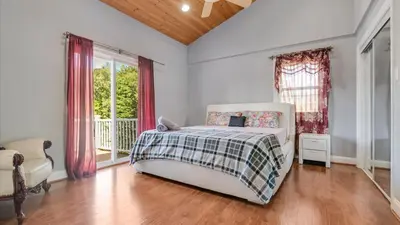 a bedroom with a bed and a large window at Luxury Lake Front Camelot Villa in Pocono Lake