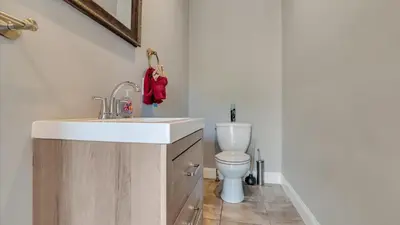 a bathroom with a sink and a toilet at Luxury Lake Front Camelot Villa in Pocono Lake